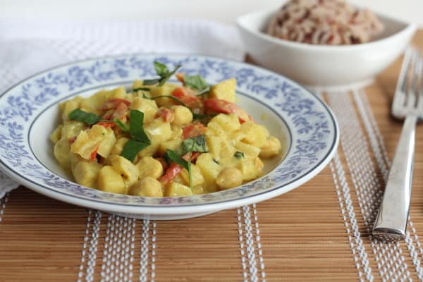 Potato Curry with Mango and Basil in a blue and white bowl