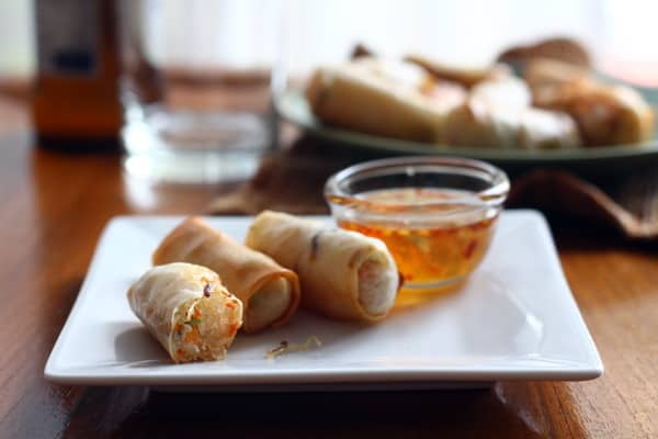 Vegetarian Baked Spring Rolls spring rolls and dipping sauce on a square white plate