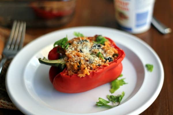 a stuffed red bell pepper on a white plate