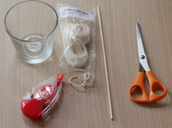 scissors, skewer, wick, and a jar on a table