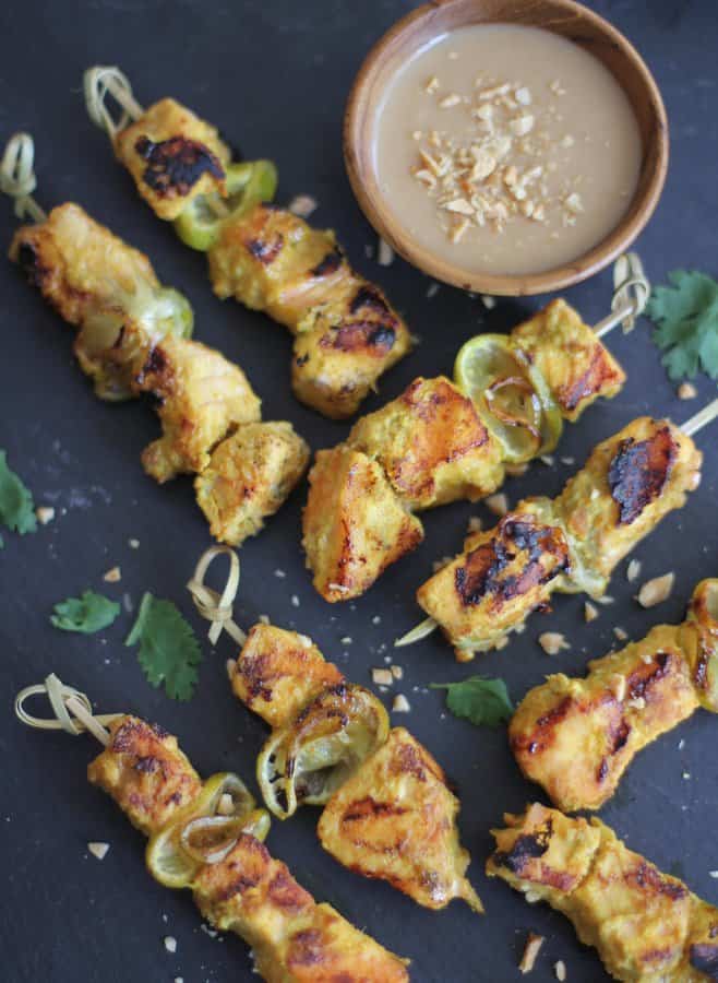 salmon skewers with peanut dipping sauce on a grey countertop