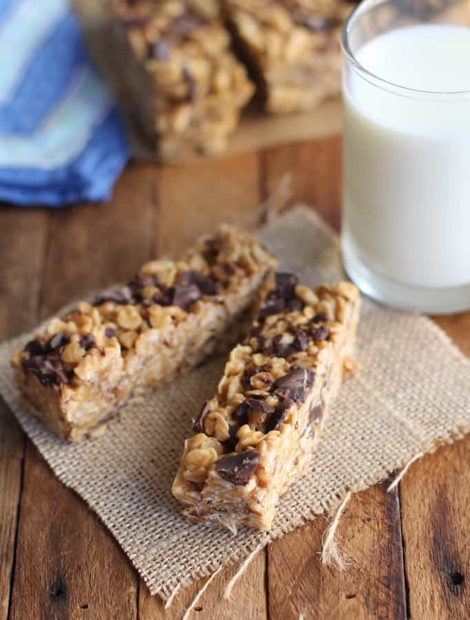 homemade bars on a wooden table with a glass of milk